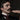 Close-up of the man's moustached face and a hand with dark red nails close to his mouth. Lacquer & Lapel