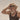 Close-up of an elderly man holding on to his straw hat with his eyes closed. Salt & Bravado
