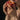 Close-up of hands holding a bitten peach to the lips, with juice dripping. Impudent Appetite