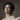 Close-up of a woman's face with her hair pinned up, a pearl earring and a lace collar. The Unrepentant Pour