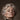 Close-up of an older woman's serious face with curly grey hair and pearl earrings. Burgundy Verdict