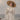 Close-up of a woman in a straw hat and a splattered white dress, her eyes closed. Seaspray Etiquette