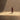 Close-up of a lone person in a red coat standing in a pool of light on the floor. Cathedral of Dust